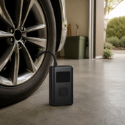 Noviquieo AirPulse Portable Tire Inflator beside a vehicle tire