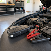 Noviquieo RoadVolt Compact Jump Starter near a car battery bay