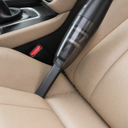 Noviquieo SwiftClean Cabin Handheld Vacuum cleaning a car seat